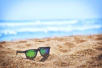 Sunglasses on a beach during summer