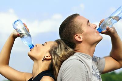 Two people with cottonmouth drinking water