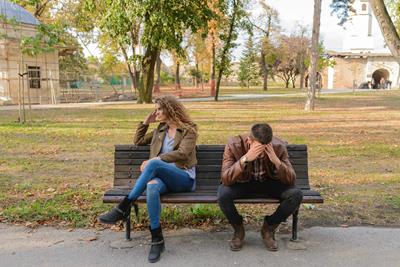 Image of a couple stressed out on a bench