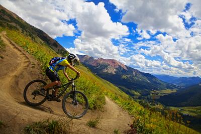 Person enjoying mountain biking in a Colorado mountain town