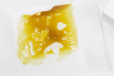 Rosin that has been pressed at home and collected onto a parchment paper.