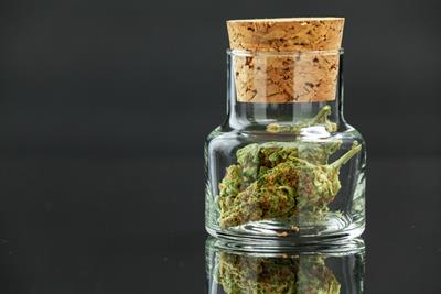 Image of a weed jar with cannabis nugs in it.