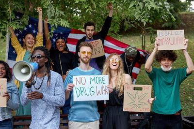 Cannabis activists holding up signs protesting the War on Drugs