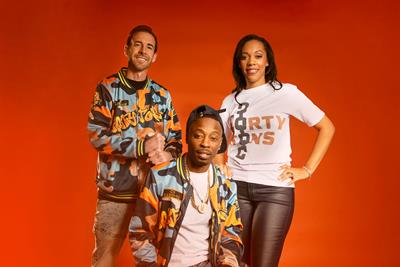 Three people posing in front of a red background wearing clothing that reads "40 Tons"