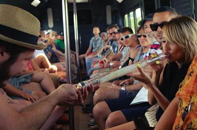 People consuming cannabis on a marijuana party bus